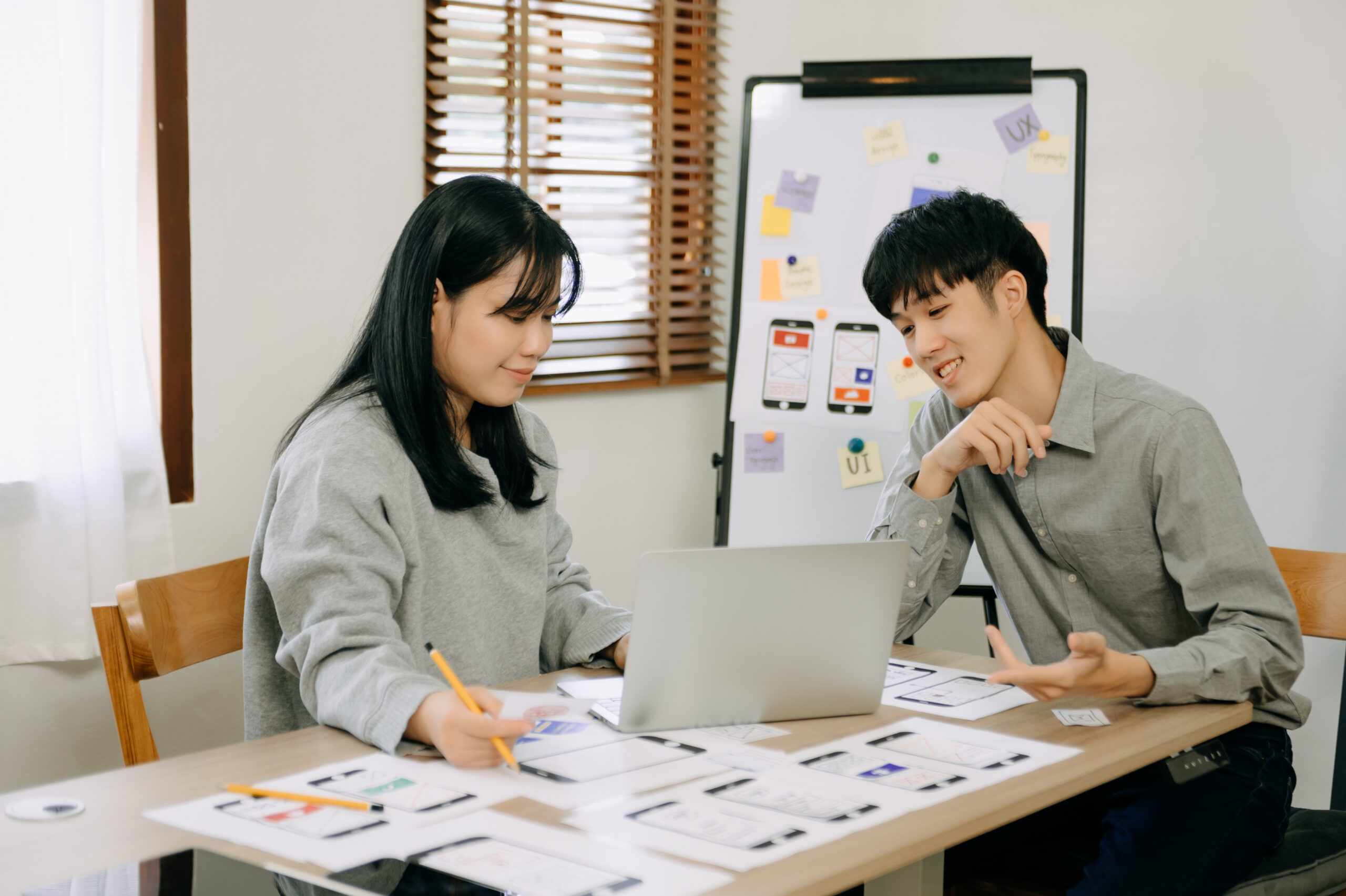 UX developer and ui designer brainstorming about mobile app int